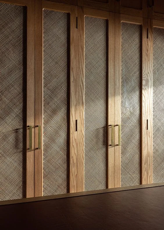 A sophisticated walnut wooden headboard in a luxurious bedroom.